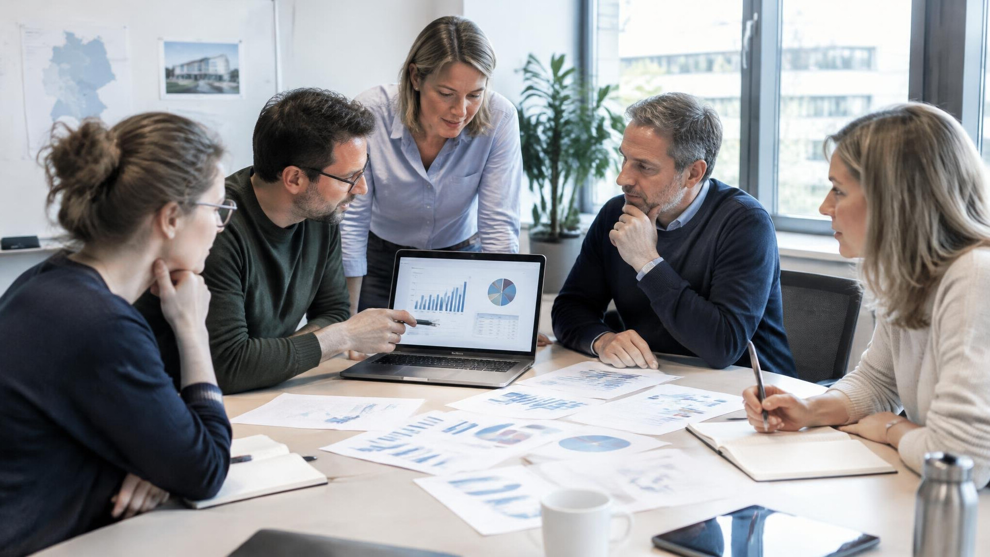 Researchers reviewing survey charts in a meeting room in Germany