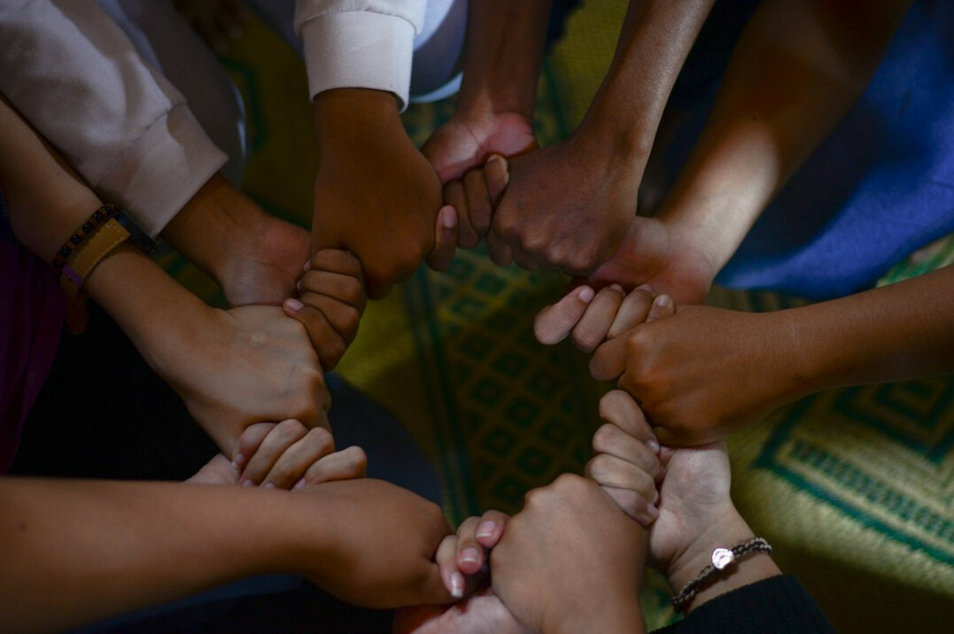 diverse group holding hands
